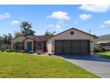 Charming single-story home with a well-maintained lawn, a two-car garage, and beautiful landscaping at 925 S Dean Cir, Deltona, FL 32738