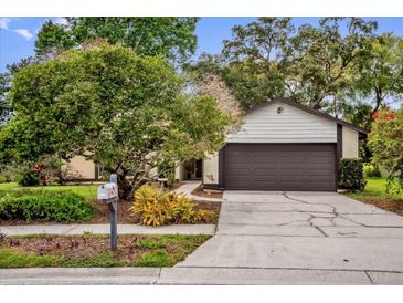 Charming single-story home with a well-maintained lawn, mature trees, and a two-car garage at 1508 Southwind Ct, Casselberry, FL 32707
