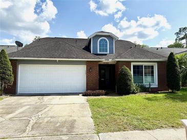 Charming single-story home with a two-car garage, brick facade, and well-manicured lawn at 4186 Buglers Rest Pl, Casselberry, FL 32707