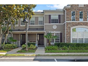Charming townhome featuring a well-maintained lawn and appealing architectural details at 461 Black Knight Way, Longwood, FL 32779