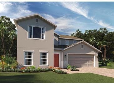 Charming two-story home showcasing a well-manicured lawn and a two-car garage at 6067 Vision Rd, St Cloud, FL 34771
