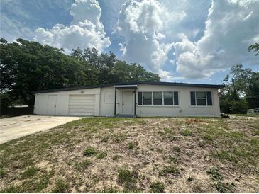 Charming single-story home featuring a large front yard and attached garage at 795 Temple Ave, Orange City, FL 32763
