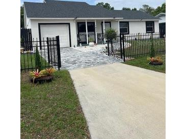 Charming single-story home with a manicured lawn and a freshly painted exterior at 1620 Hialeah St, Orlando, FL 32808