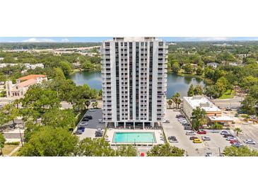 Stunning aerial view of Park Lake Towers featuring a pool, beautiful lake, and picturesque surroundings at 400 E Colonial Dr # 207, Orlando, FL 32803