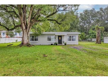 Charming single-story home with a well-maintained lawn and mature trees offering shade at 405 Willow Ave, Sanford, FL 32771
