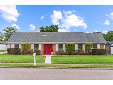 Charming single-story brick home with well-manicured lawn and bright red front door at 407 Westchester Dr, Altamonte Springs, FL 32701