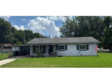 Charming single-story home with a well-maintained lawn and cozy front porch at 1975 Waldo St, Orlando, FL 32806
