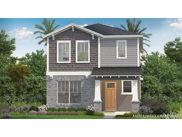 Charming two-story home featuring stone accents, gray siding, and a welcoming front porch at 2034 Education St, St Cloud, FL 34771