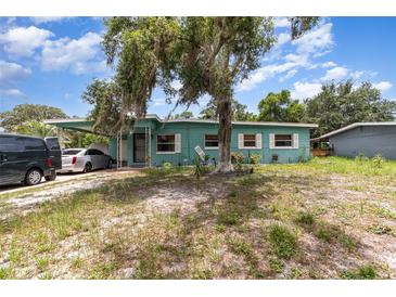 Charming single-story home with a covered carport, front yard, and mature tree at 240 W Grossenbacher Dr, Apopka, FL 32712