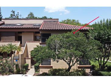 Charming condo featuring a red tiled roof and landscaped front yard, offering a cozy and inviting appeal at 2928 Lake Pineloch Blvd # Ge, Orlando, FL 32806