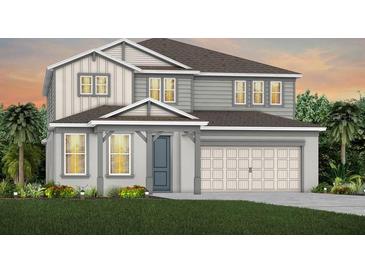 Charming two-story home featuring a two-car garage, stylish siding, and well-manicured lawn at 4116 Winding Pines Dr, Apopka, FL 32712