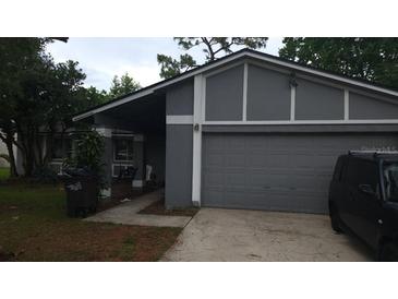 Charming single-story home with a gray exterior, attached garage, and well-maintained front yard at 885 Little Bend Rd, Altamonte Springs, FL 32714