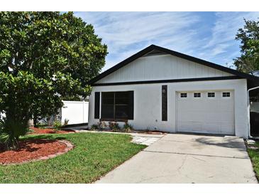 Charming home featuring a one-car garage, well-manicured lawn, and mature landscaping at 2524 Shadybranch Dr, Orlando, FL 32822