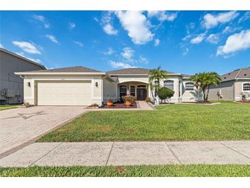 Charming single-story home featuring a well-manicured lawn and a two-car garage at 2746 Windsorgate Ln, Orlando, FL 32828