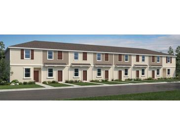 Charming townhome exterior featuring neutral siding, shuttered windows, and well-manicured landscaping at 3064 Skyline Loop, Kissimmee, FL 34758