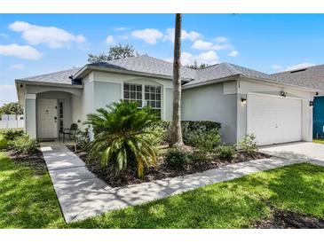Charming single-story home with well-manicured lawn and two car garage at 339 Holborn Loop, Davenport, FL 33897