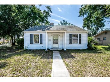 Charming one-story home with a walkway leading to the front door and classic curb appeal at 1003 S Center St, Eustis, FL 32726