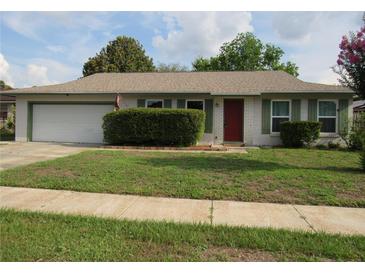 Charming single-story home with a well-maintained front yard and a two-car garage at 10208 Brownwood Ave, Orlando, FL 32825