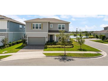 Charming two-story home featuring a well-manicured lawn and a welcoming facade at 13822 Destin Beach Ln, Orlando, FL 32827