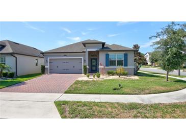 Charming single-story home featuring a well-maintained lawn and inviting brick driveway at 1727 Butterfly Way, Longwood, FL 32750