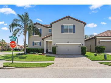 Charming two-story home with a well-maintained lawn, inviting curb appeal and a brick paved driveway at 2325 Bella Luna Cir, Lakeland, FL 33810