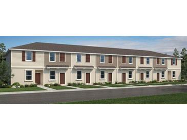 Charming townhome featuring a two-story facade, neutral colors, and well-manicured landscaping enhancing curb appeal at 3073 Skyline Loop, Kissimmee, FL 34758
