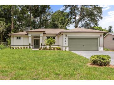 Charming single-story home with a well-manicured lawn and a two-car garage at 4770 Drummond Ln, Orlando, FL 32810