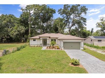 Charming home featuring a well-manicured lawn and a two car garage at 4770 Drummond Ln, Orlando, FL 32810