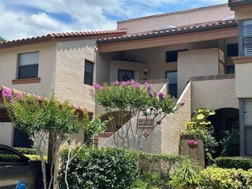 Charming townhome with colorful landscaping and a well-maintained facade offering curb appeal at 1252 Lake Willisara Cir # Ge, Orlando, FL 32806