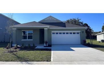 Charming one-story home featuring a two-car garage and well-maintained landscaping at 220 Taylor Groves St, Lake Wales, FL 33898