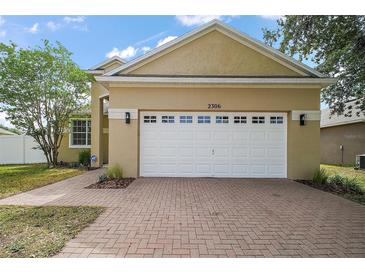 Charming single-Gathering home with a two-car garage and brick paver driveway at 2306 Valhalla Dr, Tavares, FL 32778