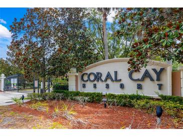 A welcoming community entrance with lush landscaping and prominent signage at 2411 Caravelle Cir, Kissimmee, FL 34746