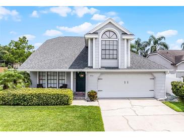 Charming two-story home with a well-manicured lawn, lush green bushes, and a welcoming front entrance at 754 Birgham Pl, Lake Mary, FL 32746