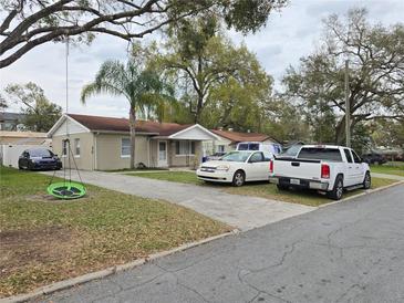 Charming single-story home featuring a welcoming front yard and a long private driveway at 864 E Lowell St, Lakeland, FL 33805