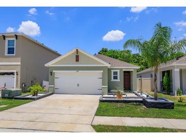 Charming single-Gathering home with a well-manicured lawn, inviting entry, and two-car garage at 1287 Berry Ln, Davenport, FL 33837