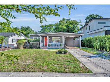 Charming single-story home featuring a quaint front porch, covered parking, and a well-maintained lawn at 1511 Chestnut Ave, Winter Park, FL 32789