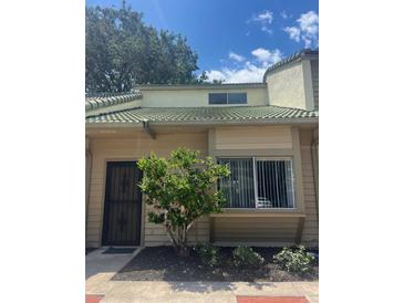 Two-story home featuring neutral color scheme, wrought iron door, and well-maintained landscaping at 460 Sand Lime Rd, Winter Garden, FL 34787