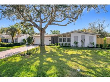 Charming single-story home featuring a lush lawn, mature tree, and brick accents, creating a welcoming curb appeal at 2520 Chanute Trl, Maitland, FL 32751