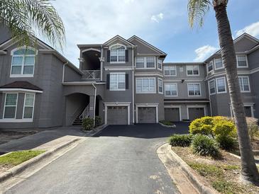 Attractive gray building exterior featuring multiple units and garage parking at 3391 S Kirkman Rd # 1236, Orlando, FL 32811