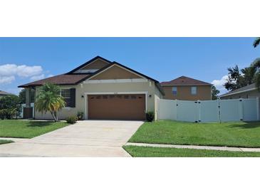 Charming single-story home with well-manicured lawn and a two-car garage at 3529 Harlequin Dr, St Cloud, FL 34772