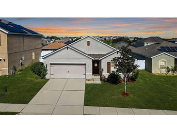 Charming single-Gathering home features a well-manicured lawn and attached two-car garage at 356 Nova Dr, Davenport, FL 33837