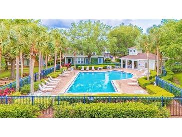 Community pool with chairs and tables provides a refreshing outdoor space for relaxation and socializing at 725 Ashworth Overlook Dr # C, Apopka, FL 32712