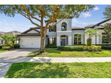 Charming two-story home featuring a well-manicured lawn, mature trees, and a two-car garage at 811 Sherbourne Cir, Lake Mary, FL 32746