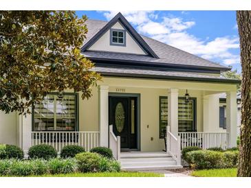 Charming single-Gathering home featuring a welcoming front porch and well-manicured landscaping at 11721 Camden Park Dr, Windermere, FL 34786