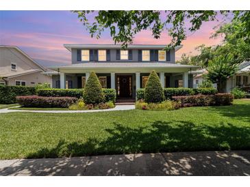 Charming two-story home with a manicured lawn and landscaped garden beds at 1355 Hibiscus Ave, Winter Park, FL 32789
