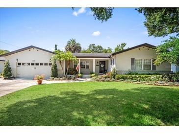 Charming single-story home with a well-manicured lawn, beautiful landscaping, and a welcoming front entrance at 2020 Geronimo Trl, Maitland, FL 32751