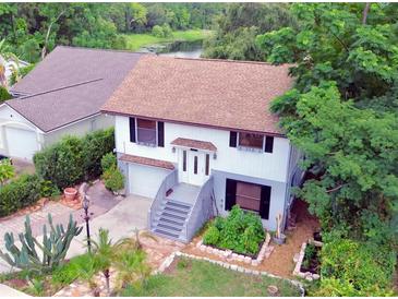 Charming home features a welcoming front yard with lush landscaping and a freshly painted exterior at 238 Lake Dr, Orlando, FL 32835