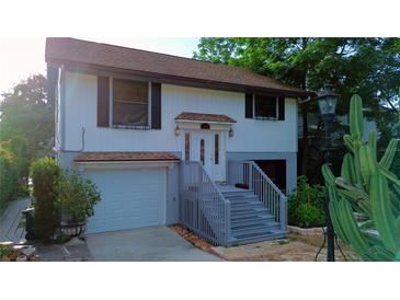 Charming two-story home with a welcoming entryway and a well-maintained front yard at 238 Lake Dr, Orlando, FL 32835