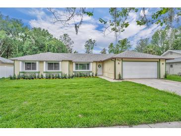 Charming single-story home featuring a well-manicured lawn and a two-car garage at 320 Bridle Path, Casselberry, FL 32707