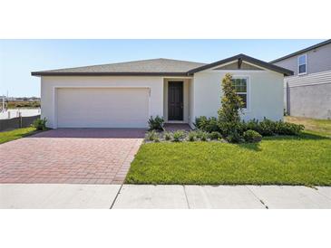 Charming single-story home featuring a brick driveway, well-maintained lawn, and neutral-toned exterior at 3253 Viceroy Ct, Poinciana, FL 34759